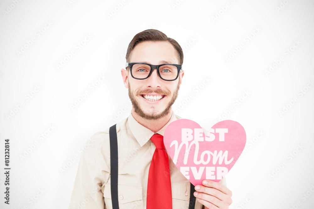 Composite image of geeky hipster smiling and holding heart card Composite image of geeky hipster smiling and holding heart card