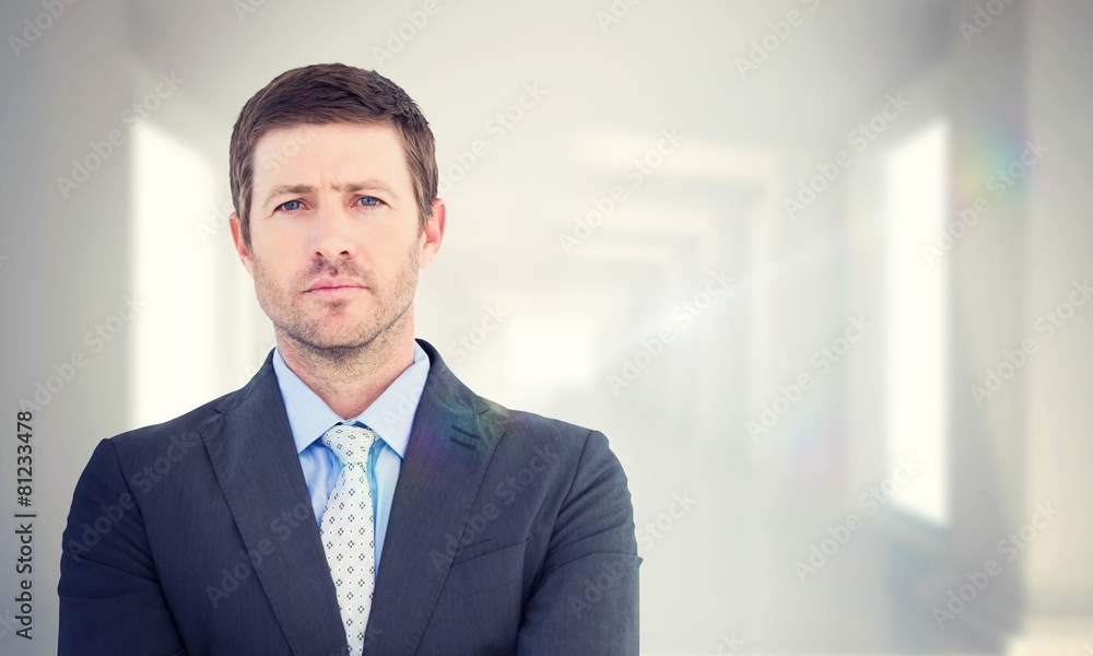 Composite image of businessman looking at the camera Composite image of businessman looking at the camera