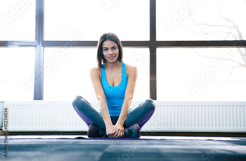 Young beautiful woman sitting on yoga mat Free Download Young beautiful woman sitting on yoga mat - GFXLoad
