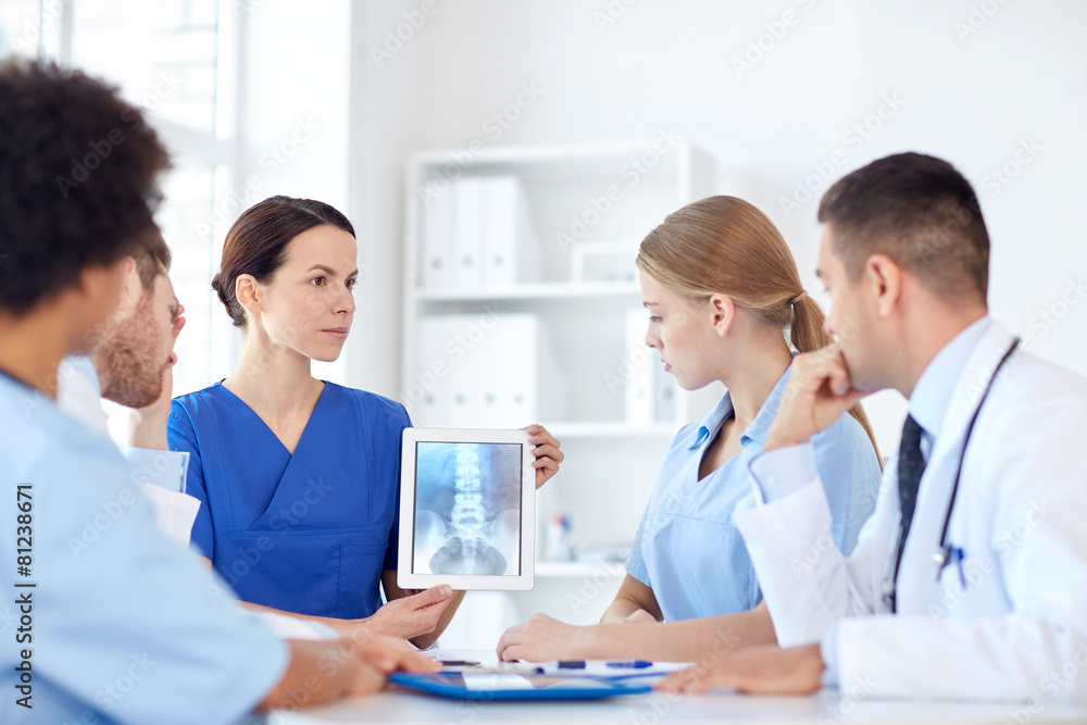 group of doctors with x-ray on tablet pc at clinic
