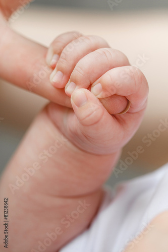 Close-up of baby's hand holding mother's finger © GTeam