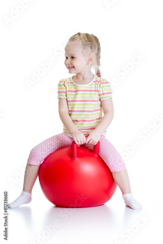 happy child jumping on bouncing ball