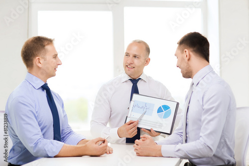 smiling businessmen with papers in office