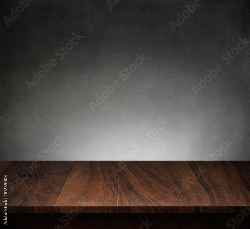 Wood table with dark concrete texture background