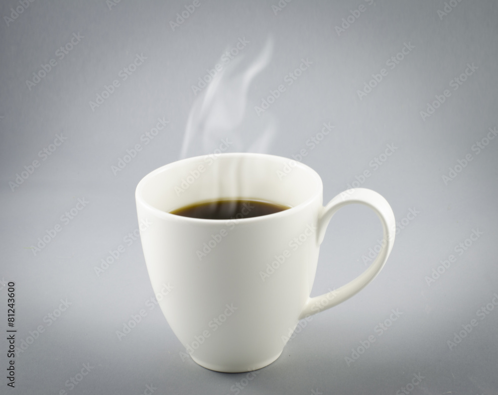 Cup of hot coffee with steam on gray background Cup of hot coffee with steam on gray background