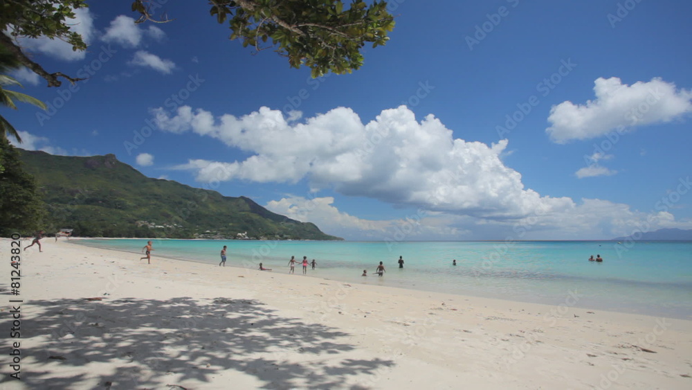 tropical beach with children in a distance tropical beach with children in a distance
