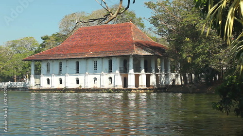 KANDY, SRI LANKA - FEBRUARY 2014: View of house on Kandy lake. Kandy is a major city in Sri Lanka, and it is the second largest city in the country after Colombo. photo