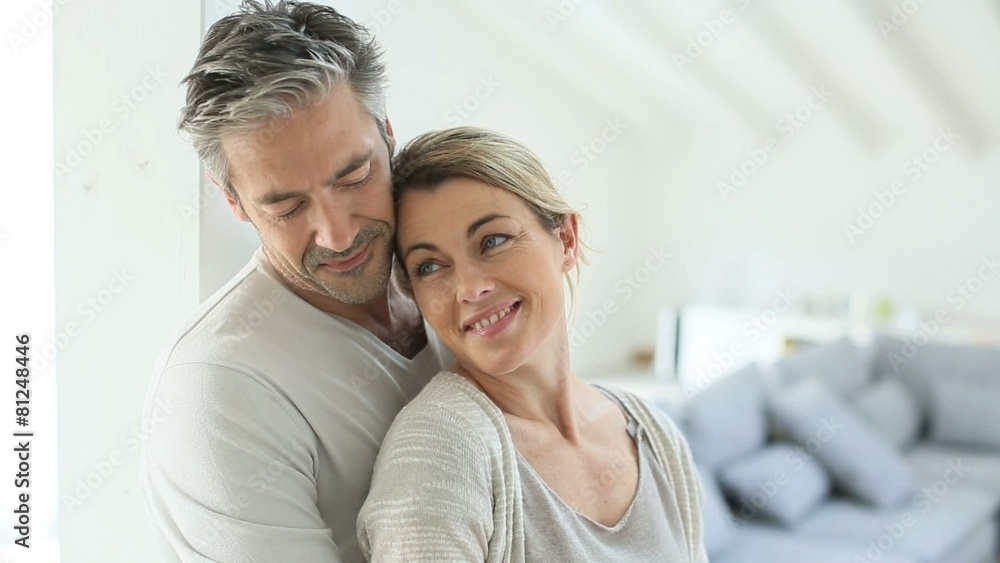 Mature couple embracing each other at home Mature couple embracing each other at home