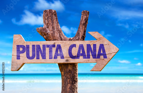 Punta Cana wooden sign with beach background photo