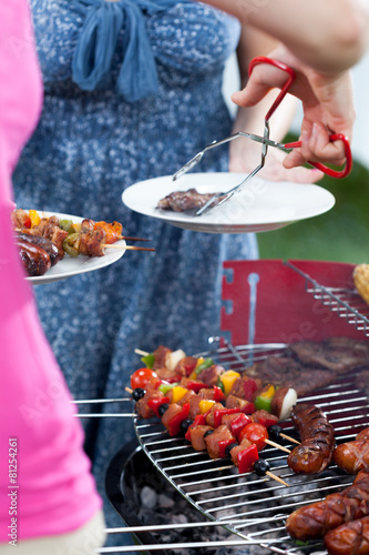 Woman serving dinner on barbecue party