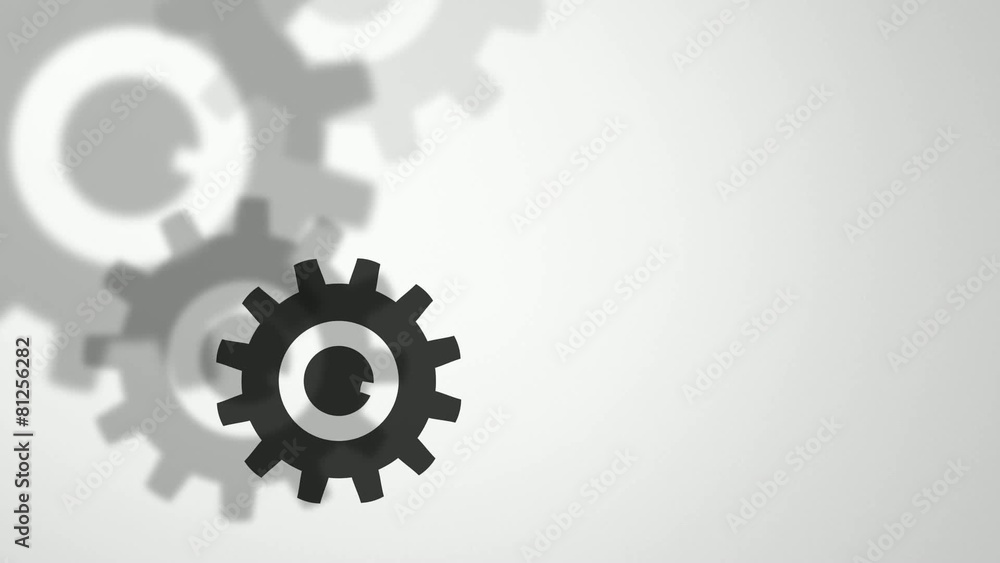 falling and rotating cog wheels on a light background falling and rotating cog wheels on a light background