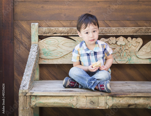 Cute Mixed Race Boy Sitting...