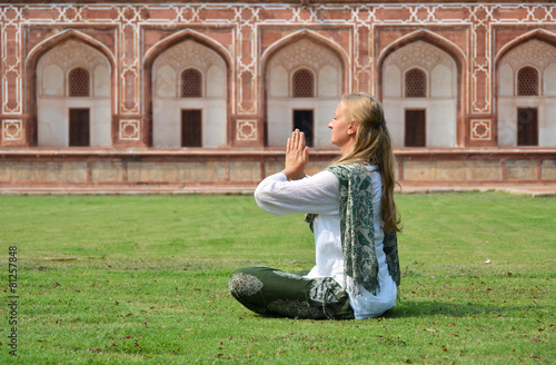 Young woman meditating in the yard of Humayun's Tomb. Delhi, Ind © HappyAlex
