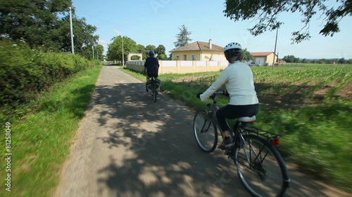 Wallpaper Mural Slow motion - Retired couple cycling on road in village in France Torontodigital.ca