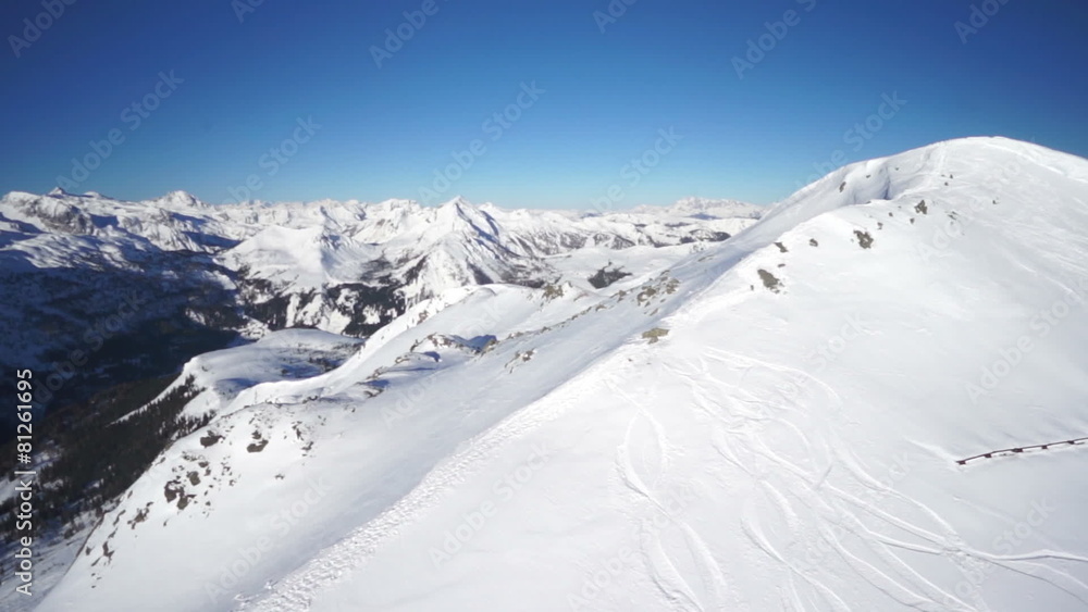 flying over snow covered crest at blue sky flying over snow covered crest at blue sky