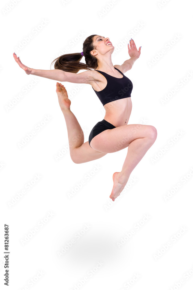 young modern ballet dancer jumping on white background