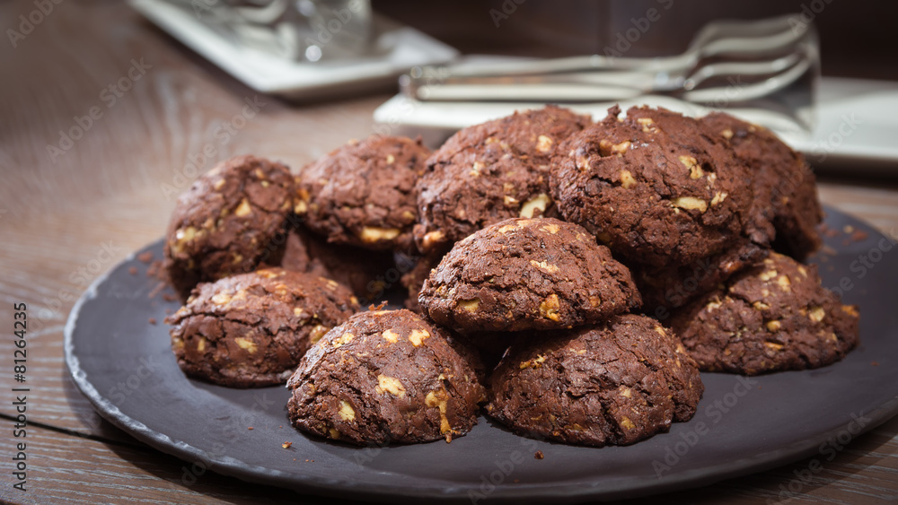 Chocolate and nut cookies on wooden table