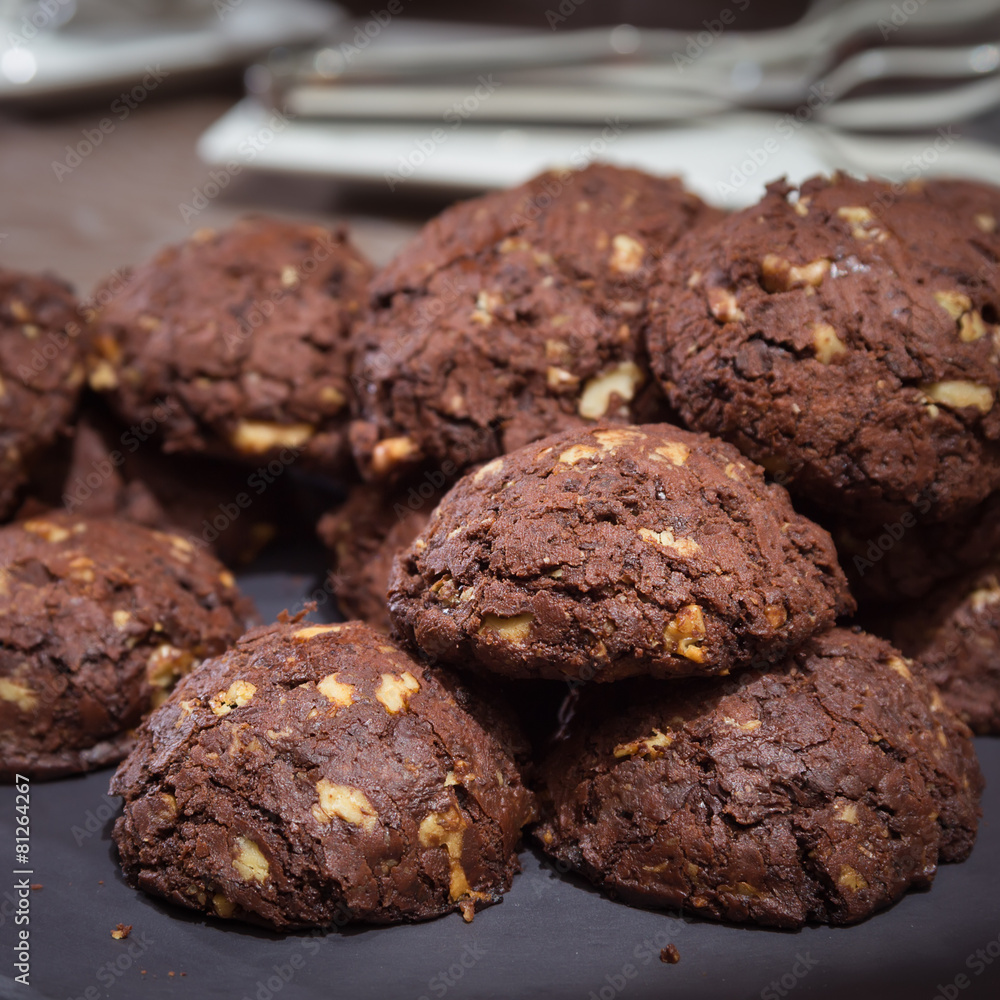 Chocolate and nut cookies on wooden table Chocolate and nut cookies on wooden table