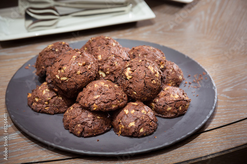 Chocolate and nut cookies on wooden table