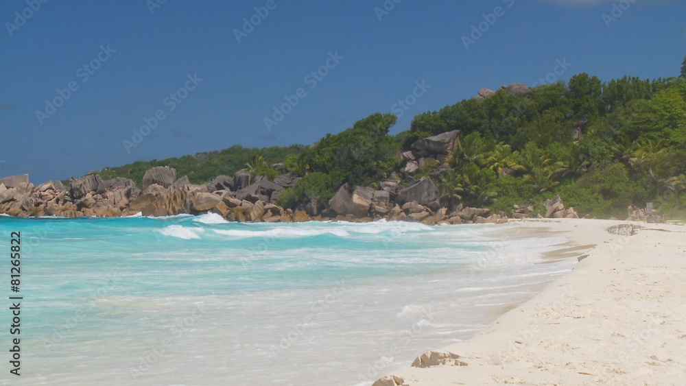waves arriving on empty sandy beach of tropical island waves arriving on empty sandy beach of tropical island