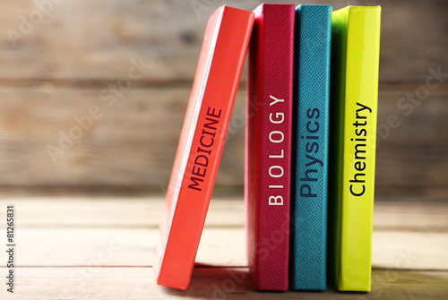 Colorful books on table on wooden background