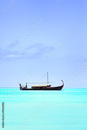 View of beautiful blue ocean water with boat in Baros Maldives