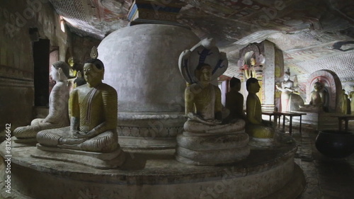 DAMBULLA, SRI LANKA - FEBRUARY 2014: Many sitting and standing Buddhas at the Golden Temple of Dambulla. The Golden Temple of Dambulla is a World Heritage Site in Sri Lanka.