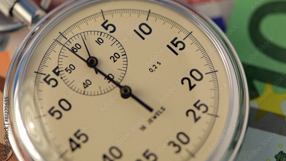 banknotes with stopwatch ticking upon them
banknotes with stopwatch ticking upon them