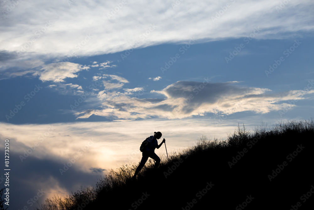 Silhouette of person heavy walking toward the summit