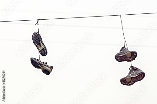 two couples fragmentary sneakers on wires