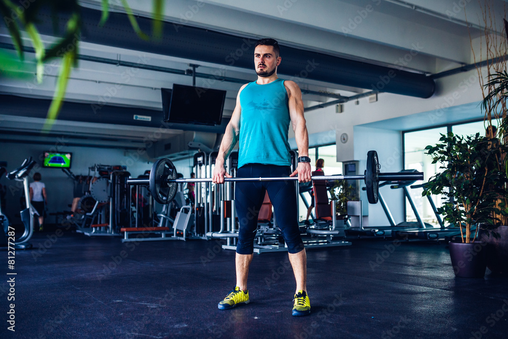 Fototapeta premium Crossfit instructor at the gym doing Deadlift exercises