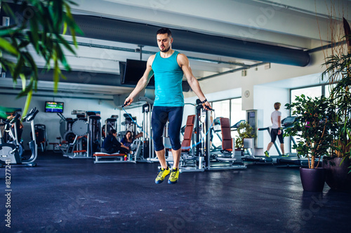 Crossfit instructor at the gym doing Exercise, jumping rope