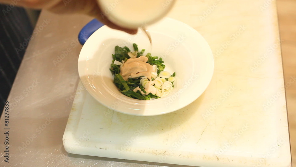 Adding mayonnaise to dish Adding mayonnaise to dish