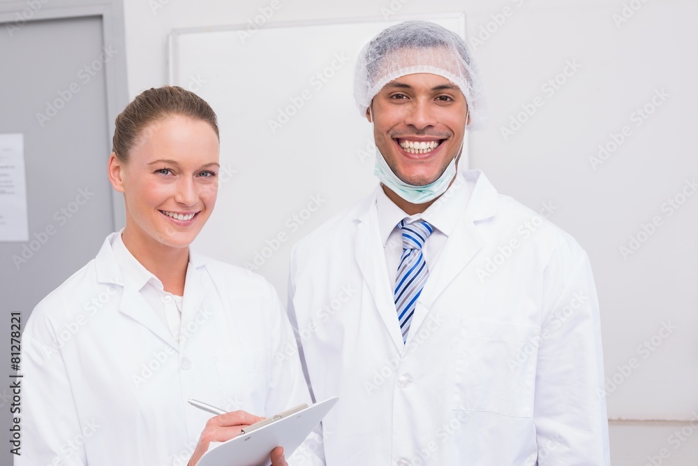 Happy scientist team smiling at camera Happy scientist team smiling at camera
