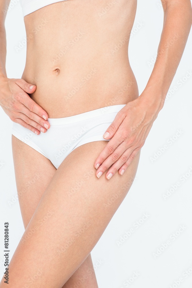 Woman touching her belly and hip