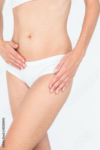 Woman touching her belly and hip