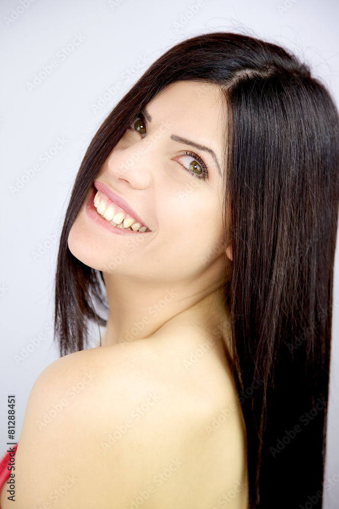 Woman with beautiful long silky hair smiling in studio Woman with beautiful long silky hair smiling in studio