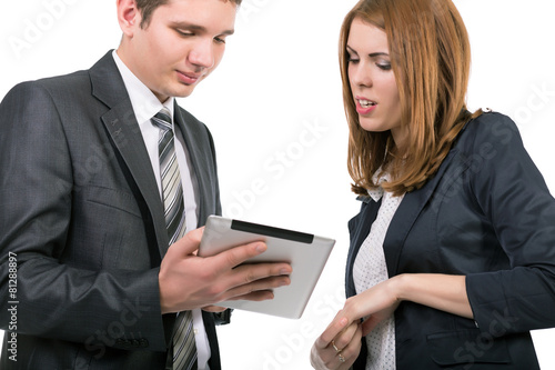 Young officially dressed people having discussion with tablet PC