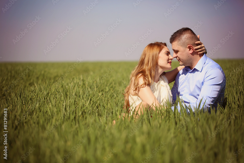 Affectionate couple sitting on grass Affectionate couple sitting on grass