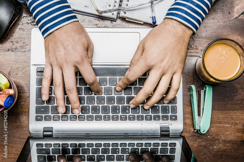 hands on the keyboard of a laptop on the desk work