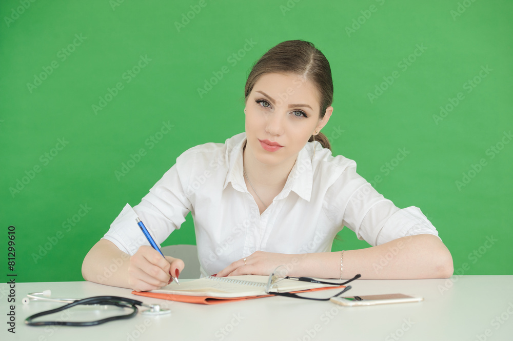 medical doctor woman writing over green screen background.. medical doctor woman writing over green screen background..