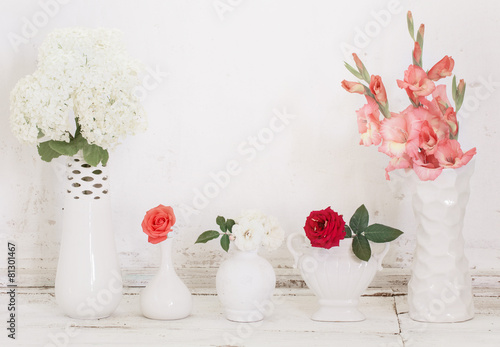 flowers on white vases on old white background