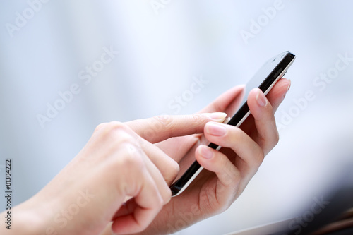 Close up of a woman using smartphone