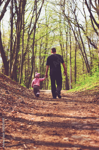 Toned portrait of Father and daughter walk in the forest.