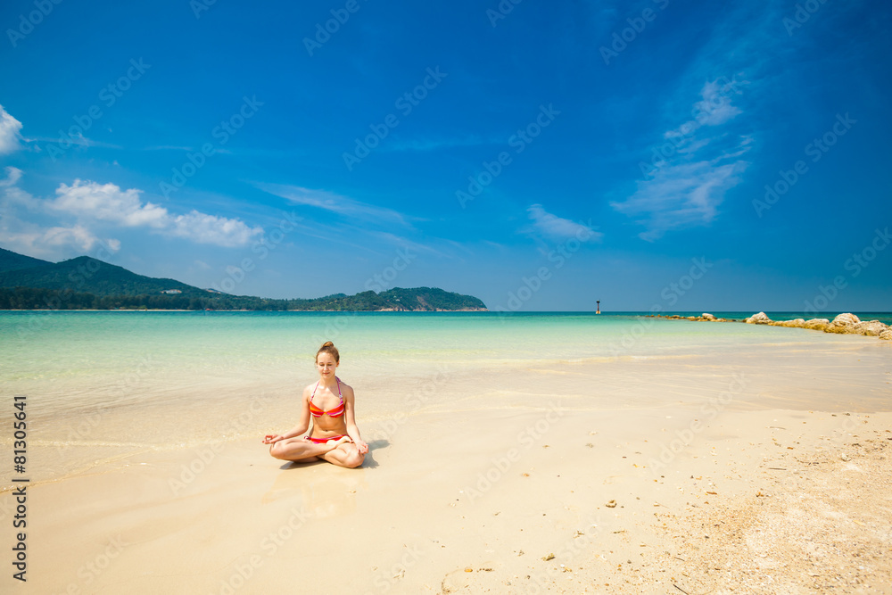 Summer yoga meditation on a beach
