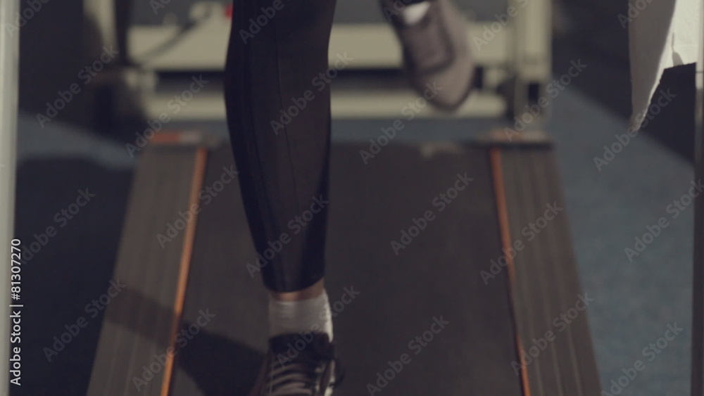 Active young woman running on a treadmill Active young woman running on a treadmill