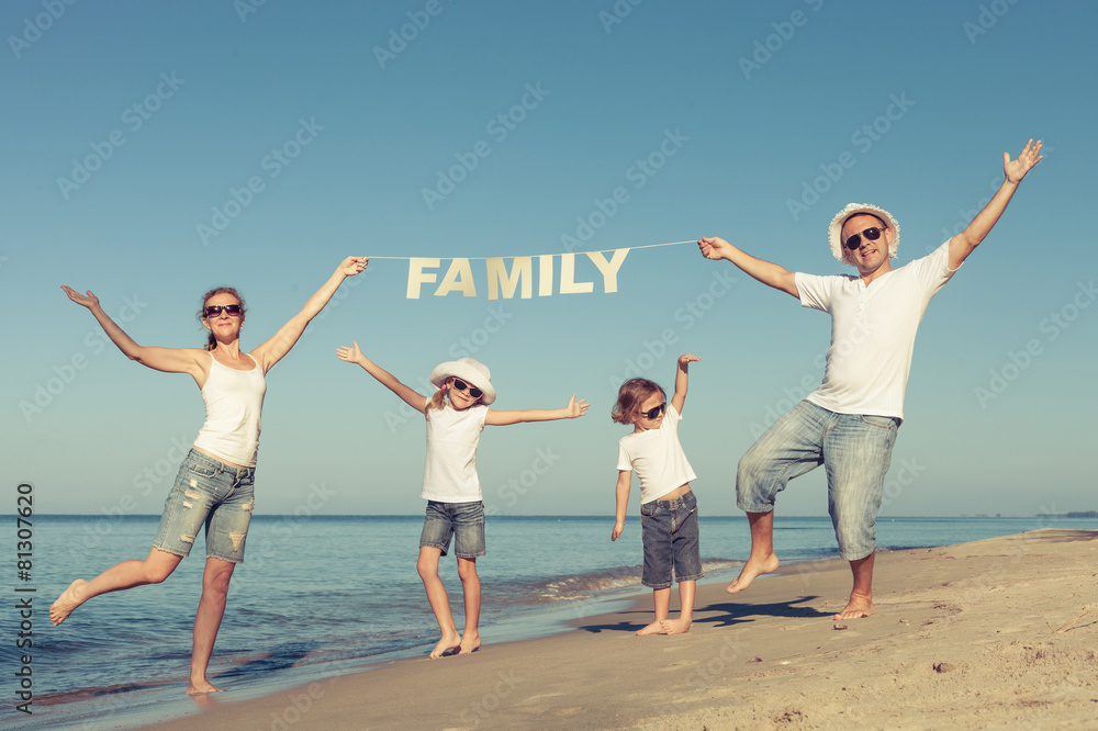 Happy family standing on the beach at the day time. Happy family standing on the beach at the day time.