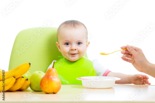 mother feeding baby girl