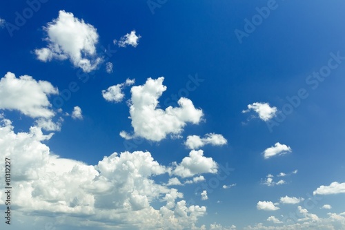Blue ultramarine sky background with white ethereal cumulus