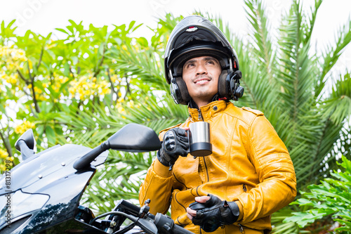 Asian man on motorcycle with helmet